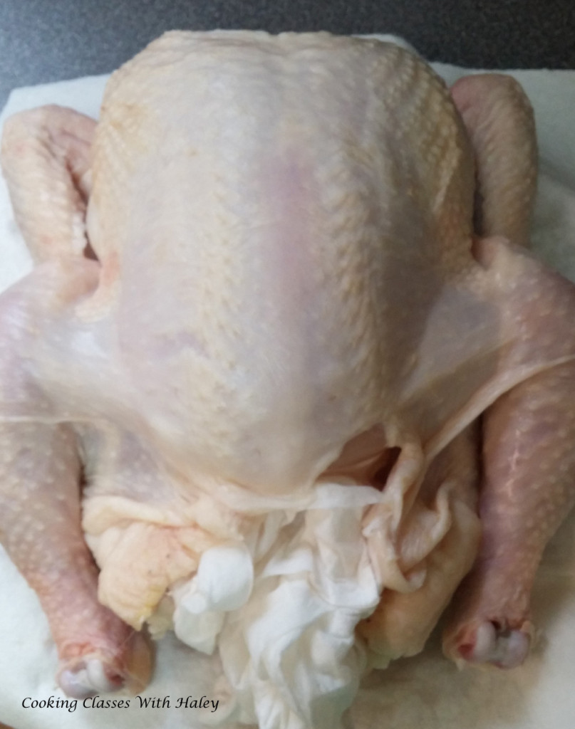 Chicken drying on paper towels breast up.